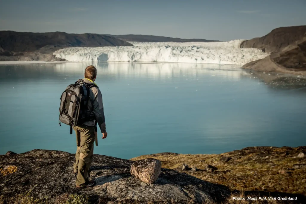 A hiker near the Eqi Glacier in North Greenland
