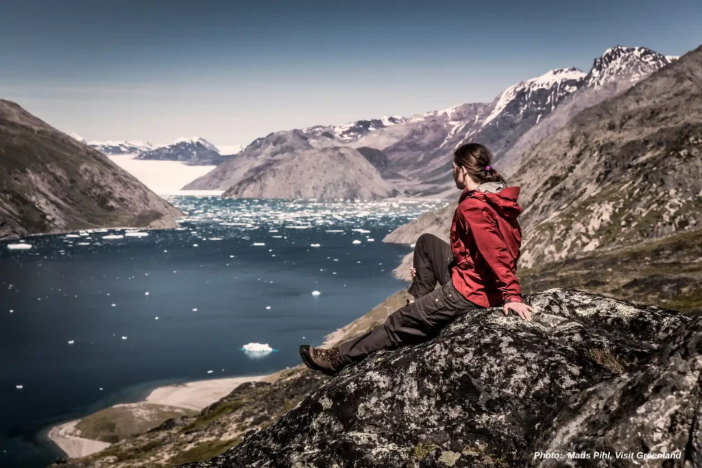 A hiker overlooking Qooroq ice fjord in South Greenland near Narsarsuaq
