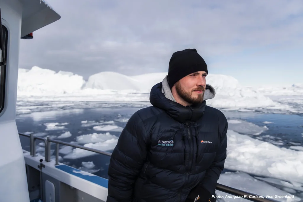 A man pausing to admire GreenlandΓÇÖs frozen giants - Photo by Aningaaq R. Carlsen - Visit Greenland