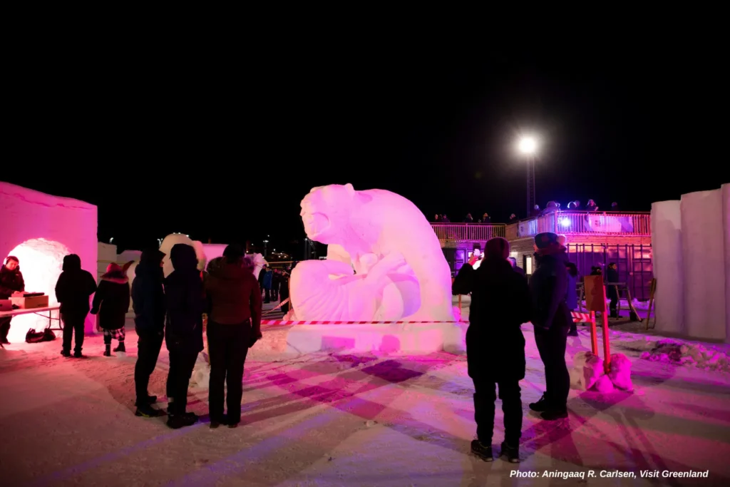 Visitors enjoying snow sculpture. Photo - Aningaaq R. Carlsen, Visit Greenland