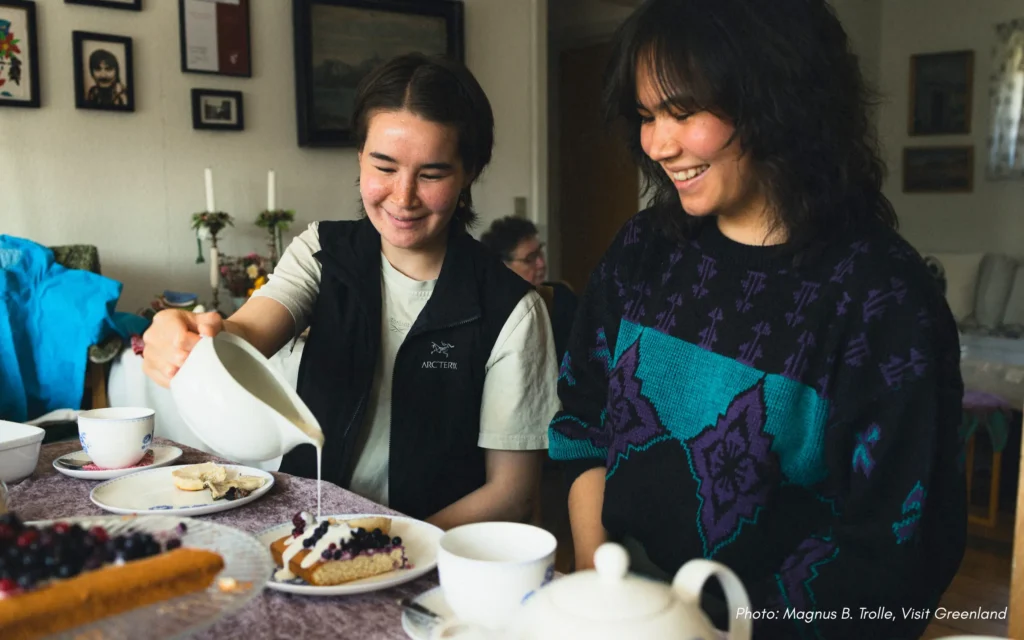 Young women smiling at kaffemik with Pink Peak Tours
