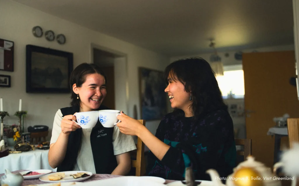 smiling with coffee and tea at kaffemik in qaqortoq